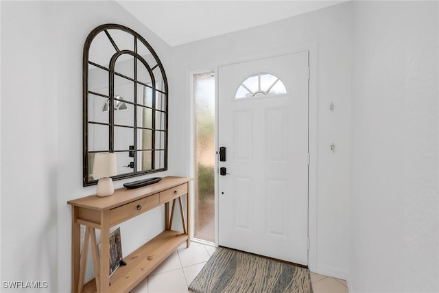 9087 Michael Cir Unit 9, Naples, FL 34113 - foyer with light tile patterned floors and baseboards