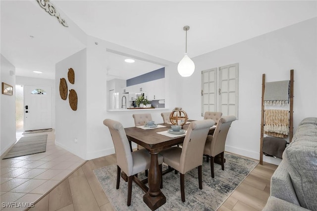9087 Michael Cir Unit 9, Naples, FL 34113 - dining room with baseboards and light wood-style floors
