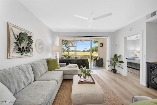 9087 Michael Cir Unit 9, Naples, FL 34113 - living room featuring light wood finished floors, baseboards, and ceiling fan