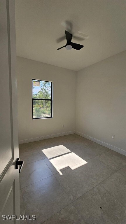 1019 Calvin Ave, Lehigh Acres, FL 33972 - empty room featuring baseboards and a ceiling fan