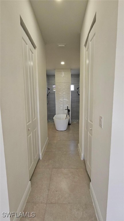 1019 Calvin Ave, Lehigh Acres, FL 33972 - hallway featuring baseboards, recessed lighting, and light tile patterned floors