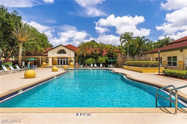 community pool with a patio area