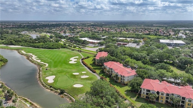 drone / aerial view of a local golf course and a nearby body of water