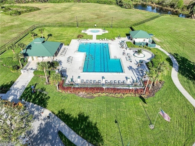 aerial view of a pool area and a large body of water