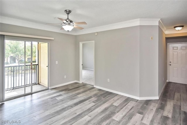spare room featuring ceiling fan, wood finished floors, baseboards, ornamental molding, and a textured ceiling
