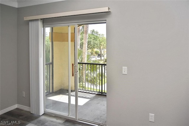 doorway to outside with baseboards and dark wood finished floors