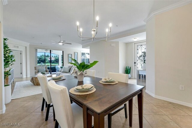 3159 Serena Ln Unit 102, Naples, FL 34114 - dining space with ornamental molding, light tile patterned flooring, a chandelier, a ceiling fan, and baseboards