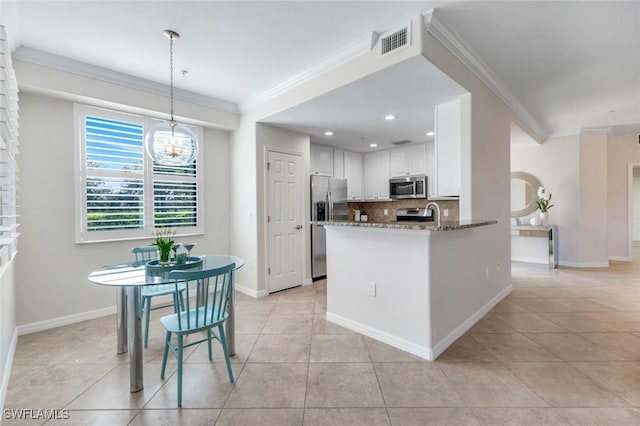3159 Serena Ln Unit 102, Naples, FL 34114 - kitchen with stainless steel appliances, ornamental molding, backsplash, stone countertops, and light tile patterned floors