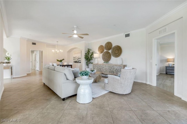 3159 Serena Ln Unit 102, Naples, FL 34114 - living room with a ceiling fan, a chandelier, crown molding, arched walkways, and light tile patterned flooring