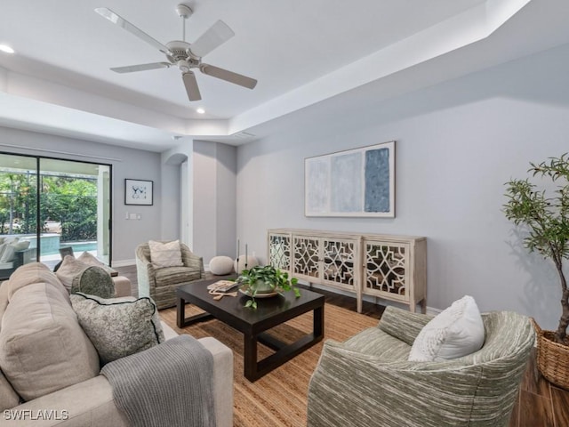 14326 Tuscany Pointe Trl, Naples, FL 34120 - living area with a raised ceiling, a ceiling fan, light wood-style flooring, recessed lighting, and arched walkways