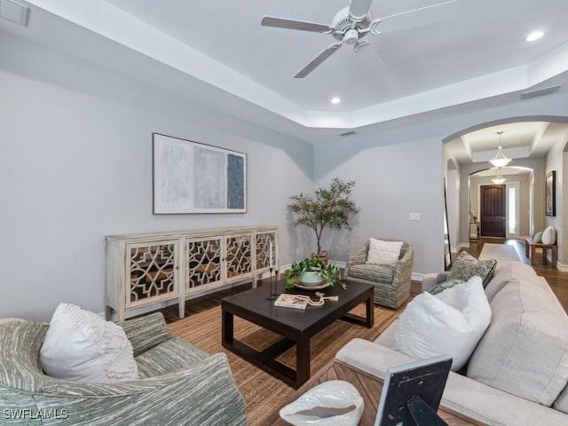 14326 Tuscany Pointe Trl, Naples, FL 34120 - living area featuring arched walkways, a raised ceiling, a ceiling fan, wood finished floors, and recessed lighting