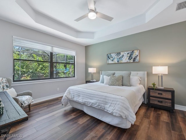 14326 Tuscany Pointe Trl, Naples, FL 34120 - bedroom featuring a tray ceiling, baseboards, wood finished floors, and a ceiling fan