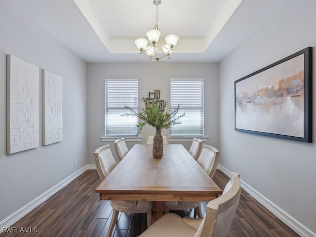 14326 Tuscany Pointe Trl, Naples, FL 34120 - dining room with a chandelier, a tray ceiling, dark wood-type flooring, and baseboards