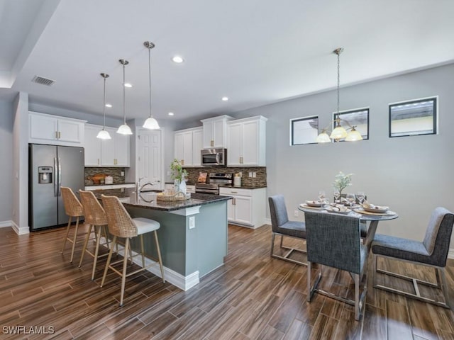 14326 Tuscany Pointe Trl, Naples, FL 34120 - kitchen with stainless steel appliances, a sink, backsplash, a kitchen bar, and recessed lighting