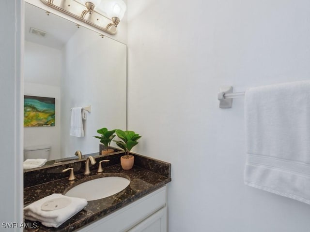 bathroom with vanity and toilet
