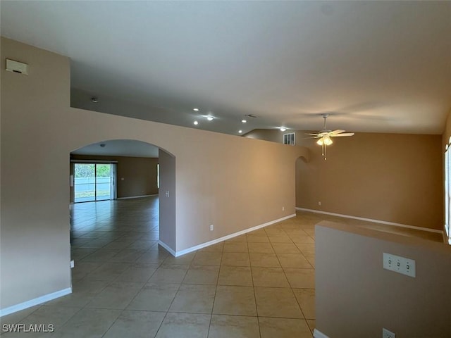 3206 35th St W, Lehigh Acres, FL 33971 - unfurnished room with arched walkways, a ceiling fan, light tile patterned floors, baseboards, and lofted ceiling