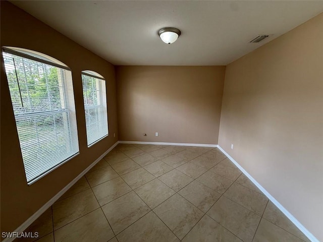 3206 35th St W, Lehigh Acres, FL 33971 - spare room featuring light tile patterned floors and baseboards