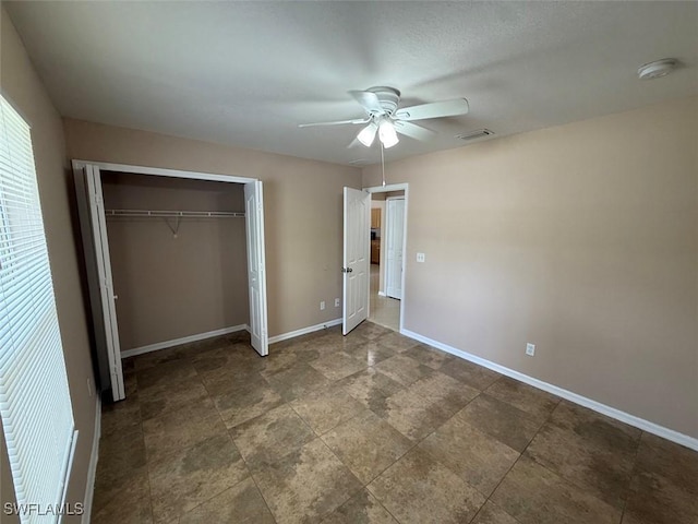 3206 35th St W, Lehigh Acres, FL 33971 - unfurnished bedroom featuring a closet, baseboards, and a ceiling fan