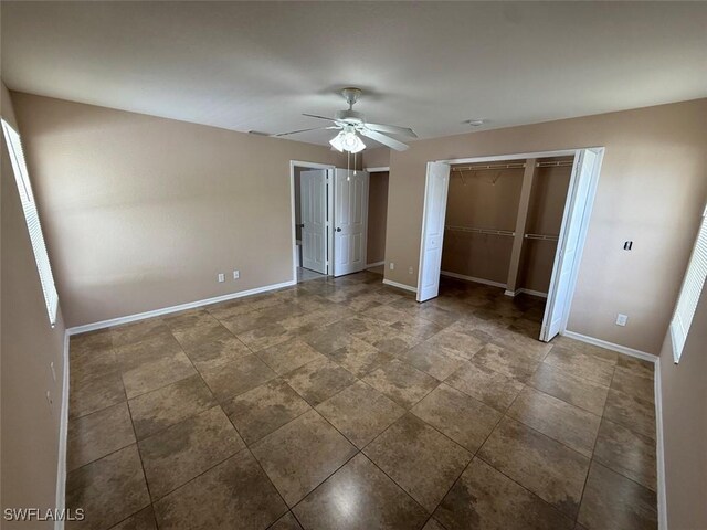 3206 35th St W, Lehigh Acres, FL 33971 - unfurnished bedroom with baseboards and ceiling fan