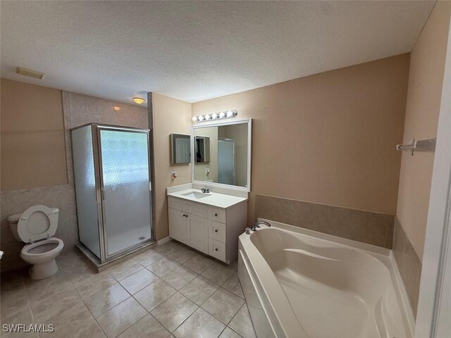 3206 35th St W, Lehigh Acres, FL 33971 - bathroom featuring toilet, tile patterned flooring, vanity, a garden tub, and a shower stall