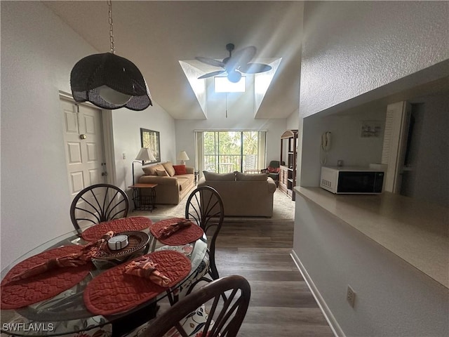 9970 Sailview Ct Unit 19, Fort Myers, FL 33905 - dining area with a ceiling fan, dark wood-style floors, lofted ceiling, and baseboards