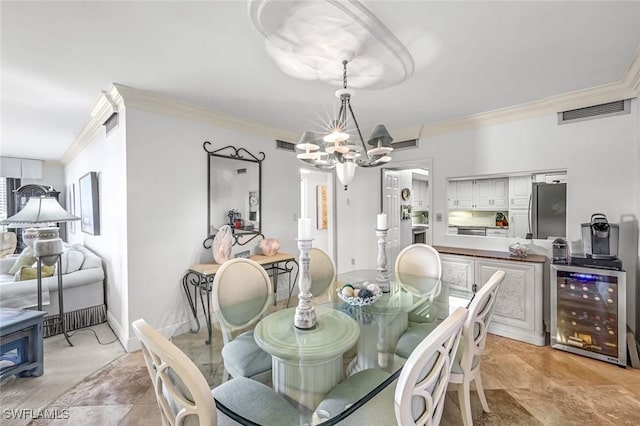 174 S Collier Blvd Unit 304, Marco Island, FL 34145 - dining room with crown molding, wine cooler, and a chandelier