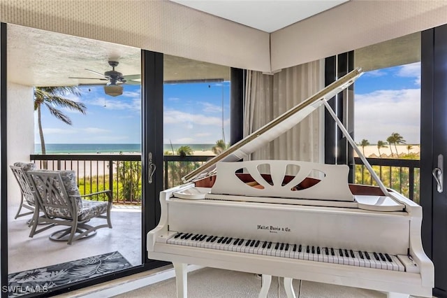 174 S Collier Blvd Unit 304, Marco Island, FL 34145 - sitting room featuring a ceiling fan and a water view