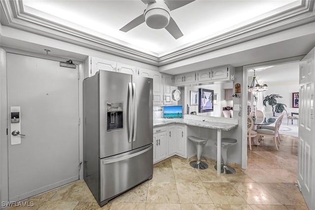 174 S Collier Blvd Unit 304, Marco Island, FL 34145 - kitchen featuring stainless steel fridge, a ceiling fan, a chandelier, and white cabinets
