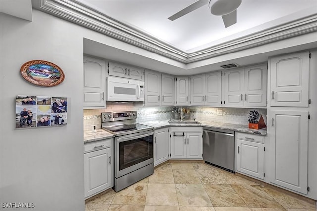 174 S Collier Blvd Unit 304, Marco Island, FL 34145 - kitchen with appliances with stainless steel finishes, decorative backsplash, a ceiling fan, and a sink