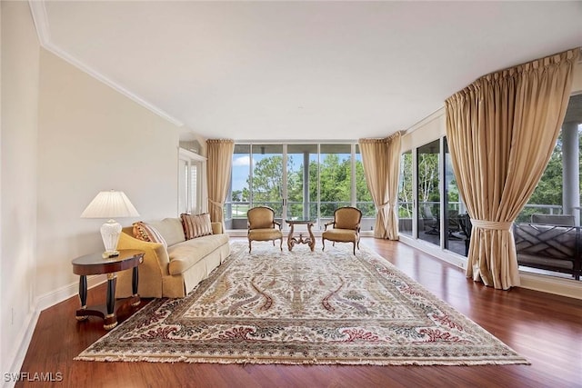 2630 Grey Oaks Dr N Unit B18, Naples, FL 34105 - living area with crown molding, wood finished floors, and baseboards