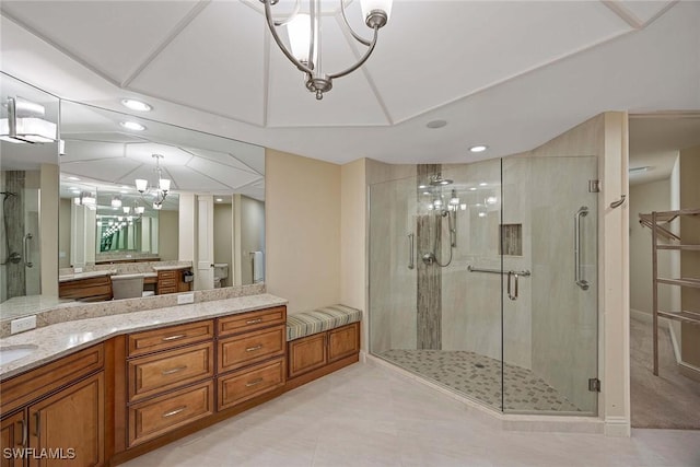 2630 Grey Oaks Dr N Unit B18, Naples, FL 34105 - bathroom featuring a chandelier, a stall shower, recessed lighting, vanity, and tile patterned flooring