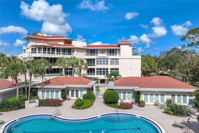 2630 Grey Oaks Dr N Unit B18, Naples, FL 34105 - community pool featuring french doors and a patio
