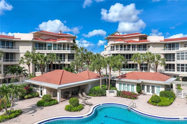 2630 Grey Oaks Dr N Unit B18, Naples, FL 34105 - community pool featuring a patio