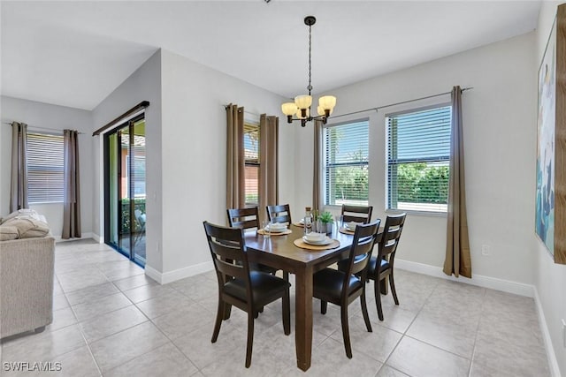 dining room with a chandelier, healthy amount of natural light, and light tile patterned floors