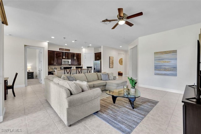 living room with light tile patterned flooring, a ceiling fan, baseboards, and recessed lighting