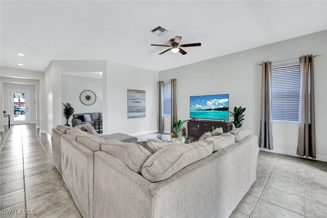 living area with light tile patterned floors, ceiling fan, baseboards, and recessed lighting