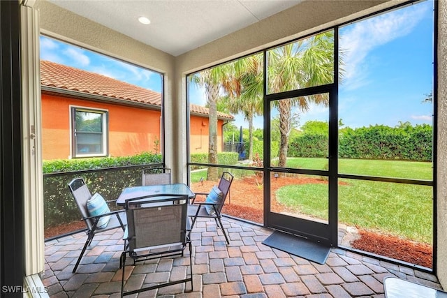 sunroom with outdoor dining area