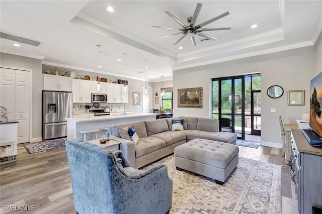 7824 7th Ter, Labelle, FL 33935 - living room featuring a tray ceiling, ceiling fan, recessed lighting, light wood-type flooring, and ornamental molding