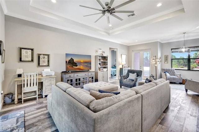 7824 7th Ter, Labelle, FL 33935 - living area with a tray ceiling, wood finished floors, ceiling fan, recessed lighting, and crown molding