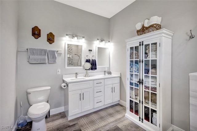 7824 7th Ter, Labelle, FL 33935 - full bath with toilet, wood finished floors, double vanity, and baseboards