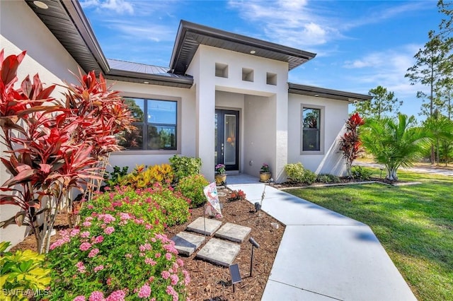 7824 7th Ter, Labelle, FL 33935 - entrance to property with stucco siding and a lawn