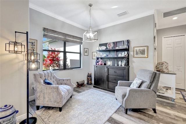 7824 7th Ter, Labelle, FL 33935 - living area featuring light wood-style floors, crown molding, a chandelier, baseboards, and recessed lighting