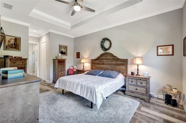 7824 7th Ter, Labelle, FL 33935 - bedroom with a raised ceiling, wood finished floors, baseboards, a closet, and ornamental molding