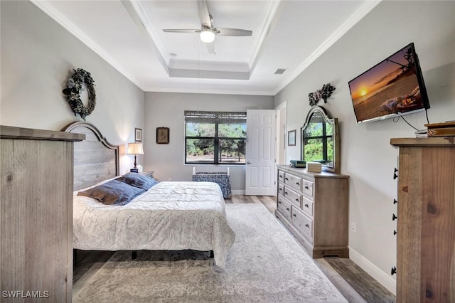 7824 7th Ter, Labelle, FL 33935 - bedroom featuring wood finished floors, a raised ceiling, ornamental molding, ceiling fan, and baseboards