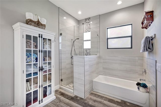 7824 7th Ter, Labelle, FL 33935 - bathroom with a shower stall, a bath, recessed lighting, and wood finished floors
