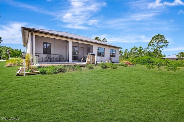 7824 7th Ter, Labelle, FL 33935 - back of house featuring a lawn, stucco siding, a sunroom, and a ceiling fan