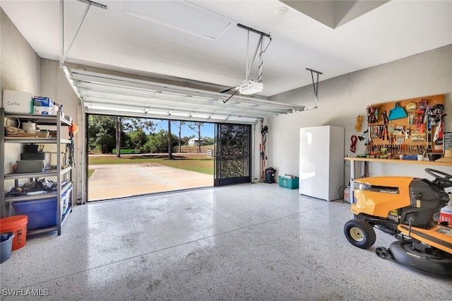 7824 7th Ter, Labelle, FL 33935 - garage with freestanding refrigerator and a garage door opener