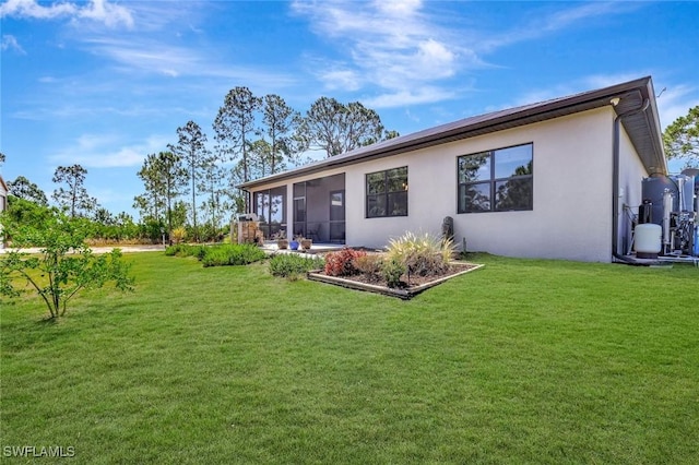7824 7th Ter, Labelle, FL 33935 - back of house with stucco siding, a yard, and a sunroom