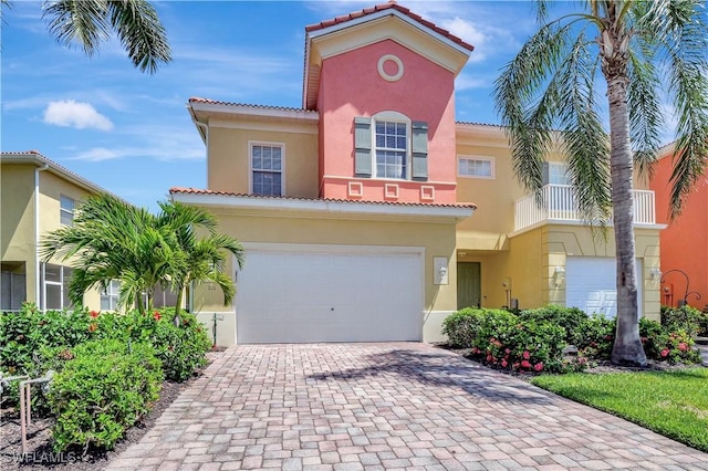 9820 Healthpark Cir Unit 101, Fort Myers, FL 33908 - mediterranean / spanish house with stucco siding, decorative driveway, a tiled roof, and a garage