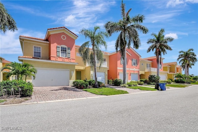 9820 Healthpark Cir Unit 101, Fort Myers, FL 33908 - view of front of property featuring a tiled roof, driveway, stucco siding, and an attached garage
